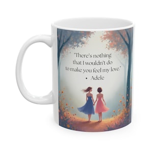 May include: White ceramic mug featuring a romantic illustration of two women walking hand-in-hand through a forest. The mug includes the quote "There's nothing that I wouldn't do to make you feel my love." by Adele.