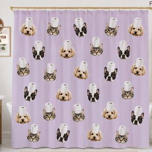 May include: A light purple shower curtain featuring a repeating pattern of various dog and cat faces, each wearing a white toilet paper roll on their head. The top right corner of the curtain displays the text PAWSTER in a simple black font.
