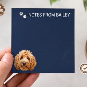 May include: A square navy blue notepad featuring the white text "NOTES FROM BAILEY" at the top, accompanied by two small white paw print icons. The bottom left corner displays a realistic, detailed colour portrait of a golden-brown doodle dog.