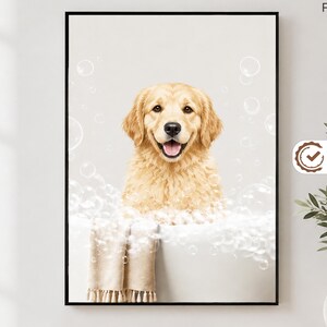 May include: A framed wall art print featuring a golden retriever dog sitting in a white bathtub filled with soap bubbles. The dog has light golden fur and is looking forward with an open mouth. A beige towel hangs over the edge of the tub.