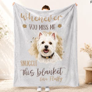 May include: A light gray blanket featuring a West Highland White Terrier illustration with the text "Whenever you miss me, snuggle this blanket love Fluffy." The dog has a black collar with a gold buckle.