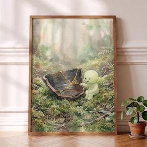 May include: A framed watercolor painting depicting a small, pale green, round-headed creature sitting on a mossy forest floor next to a broken dark gray bowl repaired with gold lacquer lines, set against a soft, hazy, light-filled woodland background.