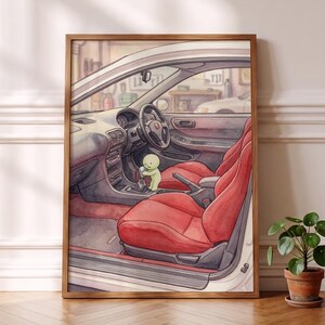 May include: A framed watercolor illustration depicting the interior of a car with bright red bucket seats, a dark dashboard, and a steering wheel. A small, light green cartoon character is positioned in the center, holding the gear shift lever.