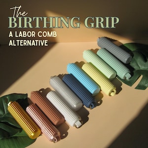 May include: A collection of cylindrical, textured silicone grips arranged in a diagonal row. The text "The BIRTHING GRIP A LABOR COMB ALTERNATIVE" is printed at the top. The grips come in various colors including gold, pink, brown, white, blue, yellow, and green.
