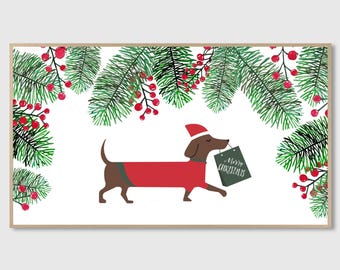 May include: A framed print featuring a dachshund wearing a red sweater and Santa hat, holding a sign that reads "Merry Christmas." The dog is set against a backdrop of green pine branches and red berries, creating a festive holiday scene.