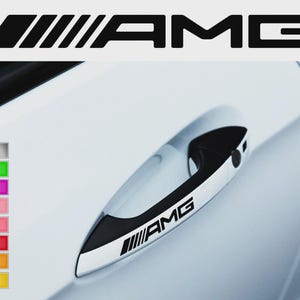 May include: Black and white AMG logo sticker and car door handle sticker. The AMG logo is displayed above the car door handle. The car door handle has the AMG logo on it. A color chart is on the left side of the image.