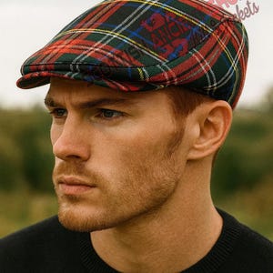 May include: A traditional flat cap in a tartan design, featuring red, green, black, and yellow checks. The cap has a small peak and a fitted crown. The cap has a logo on the side. A classic headwear item.