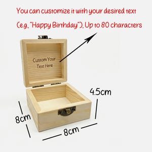 May include: Open wooden box with a hinged lid and metal clasp. The box is 8 cm x 8 cm x 4.5 cm. Text on the inside lid says "Custom Your Text Here". The text above the box says "You can customize it with your desired text (e.g., "Happy Birthday"), Up to 80 characters."