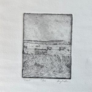 Peut inclure: Une gravure en noir et blanc intitulée "Cows" représentant un paysage rural. L'œuvre montre des vaches broutant dans un champ, avec une ligne d'arbres et un ciel lointains. L'estampe est numérotée 10/14 et signée par l'artiste.