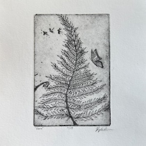 May include: A black and white etching print of a fern with a butterfly and three small birds. The print is titled "Fern" and numbered 11/15. The artwork is signed by the artist.