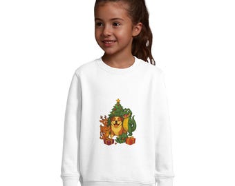 May include: White sweatshirt featuring a colorful Christmas graphic. The graphic includes a decorated Christmas tree, a dog, a reindeer, and a green alligator, with wrapped gifts at the base. The sweatshirt is worn by a young girl.