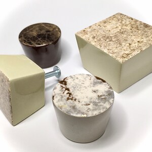 May include: Four ceramic cabinet knobs in various shapes and sizes. The knobs are in shades of brown, beige, and white with a marbled pattern.