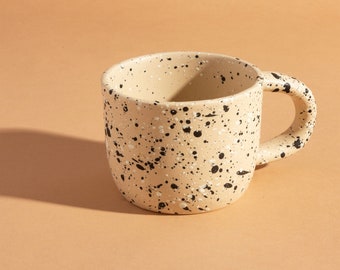 Zwart-wit gespikkeld patroon op beige mok met handvat Cup gemaakt van steengoed verjaardagscadeau voor thee koffieliefhebber voor hem en haar