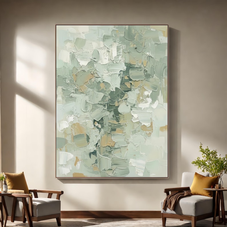 May include: Large abstract painting with a textured, impasto style. The artwork features a palette of soft greens, whites, and touches of tan. The brushstrokes are visible, creating a sense of depth and movement. The painting is framed and displayed in a well-lit room.