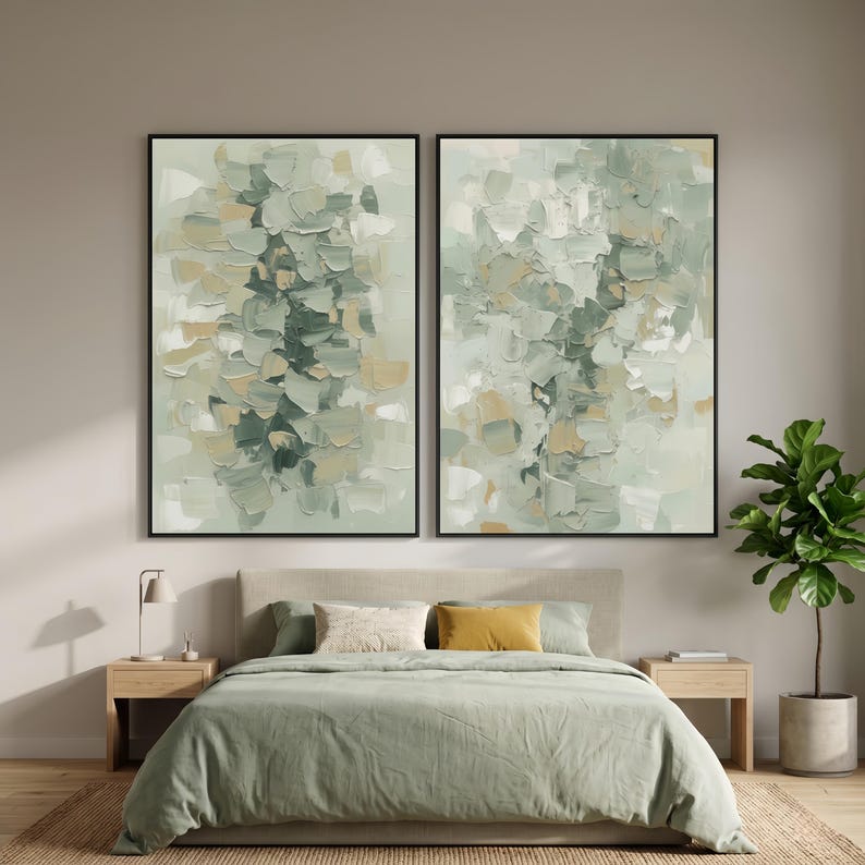 May include: Two framed abstract paintings in shades of green, beige, and white. The artwork has textured brushstrokes, creating a layered effect. The paintings are displayed above a bed with green bedding, a neutral headboard, and wooden bedside tables.