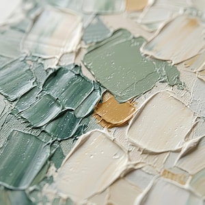 May include: Close-up of an abstract painting with thick brushstrokes. The artwork features a palette of muted greens, off-white, and a touch of gold. The textured surface creates a sense of depth and tactile quality, suggesting an oil or acrylic medium.
