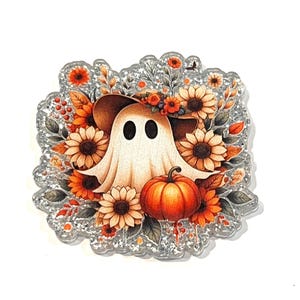May include: A Halloween-themed design featuring a friendly ghost wearing a hat and surrounded by sunflowers and a pumpkin. The design has a glittery, silver border. The ghost has two black oval eyes and a white sheet. The pumpkin is orange.