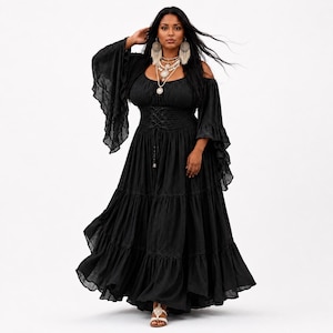 May include: A black maxi dress featuring an off-the-shoulder neckline, long flared bell sleeves with ruffled edges, and a corset-style lace-up bodice. The skirt is floor-length with tiered layers and a ruffled hem, crafted from a lightweight fabric.