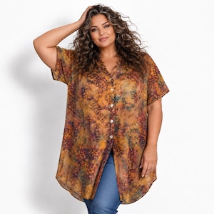 May include: A sheer, short-sleeved button-down tunic featuring an abstract, multi-coloured print in shades of burnt orange, deep yellow, dark purple, and hints of teal. The garment has a V-neckline, a full-length front button placket, and a curved hem.
