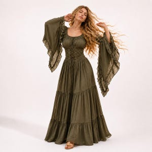 May include: An olive green floor-length dress featuring a scoop neckline, long flared bell sleeves with ruffled edges, and a corset-style lace-up bodice. The skirt is designed with multiple horizontal tiers, creating a full, flowing silhouette.