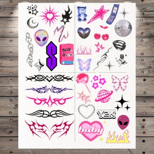 May include: A sheet of temporary tattoos featuring various Y2K-inspired designs including a purple alien head, a pink Burn Book, a flip phone, a disco ball, tribal patterns, butterflies, hearts, stars, chains, flames, and the text Y2K and baby.