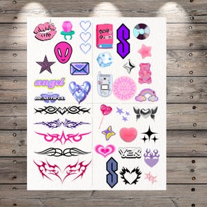 May include: A sticker sheet featuring various Y2K-themed designs including a pink glittery lip, a ring pop, a pink alien head, a purple envelope, a flip phone, a gummy bear, tribal patterns, hearts, stars, and text reading angel, beautiful, and Y2K.