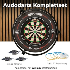 May include: A Winmau dartboard with a black surround, red and green details, and the text "BLADE6". The image shows three cameras, LED lighting, and the text "Audodarts Komplettset".