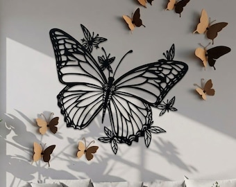 May include: A wall art installation featuring a large, black, openwork butterfly surrounded by smaller butterflies in shades of brown and tan. The butterflies are arranged on a light gray wall, creating a decorative and nature-inspired theme.