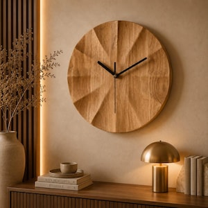 May include: A circular wall clock made of light brown wood with a faceted, geometric surface texture. The clock features three thin, black metal hands positioned at the centre. The wood grain is visible across the entire face of the clock.
