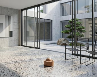 May include: An interior shot of a modern space with large glass doors and windows. The room features a terrazzo floor, concrete walls, and black metal chairs. A wooden bowl with a sphere sits on the floor, and a bonsai tree is visible outside.