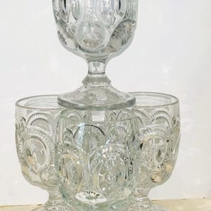 May include: A set of three ceramic mugs with a speckled, matte finish. The mugs are in shades of cream, light gray, and dark gray. Each mug has a simple, minimalist design, perfect for coffee or tea.