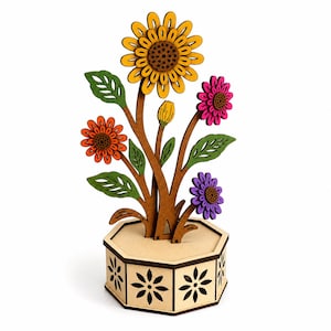 May include: A decorative wooden flower arrangement featuring a large yellow sunflower, an orange daisy, a pink flower, and a purple flower. The stems and green leaves are attached to a light brown hexagonal base with cutout flower patterns.