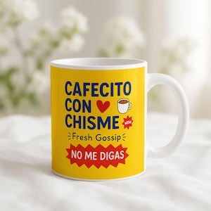 May include: White ceramic coffee mug with a bright yellow background. The mug features the text "CAFECITO CON CHISME" in blue, with a red heart and a coffee cup graphic. Below, it says "Fresh Gossip" and "NO ME DIGAS" in red.