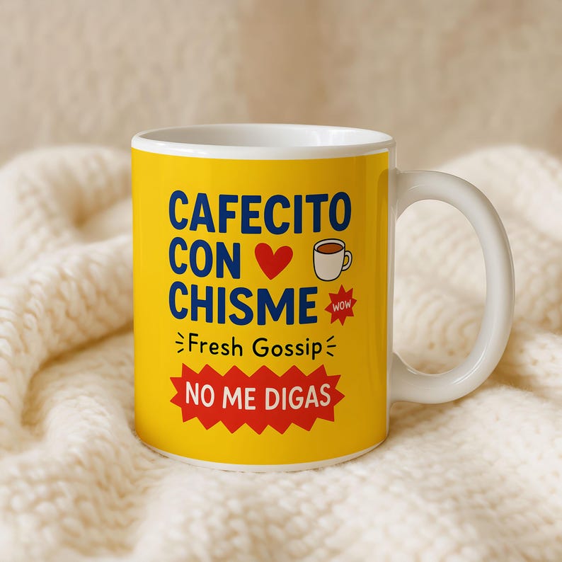 May include: A white ceramic coffee mug with a yellow exterior. The mug features the text "CAFECITO CON CHISME" in blue, a red heart, a coffee cup graphic, and the words "Fresh Gossip" and "NO ME DIGAS".