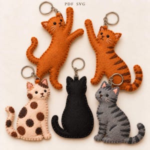 May include: Five felt cat keychains featuring various designs: a solid orange cat, a striped orange cat, a cream cat with brown spots, a solid black cat, and a grey striped cat. Each keychain includes a silver metal ring for attachment.