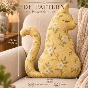 Op de afbeelding: Een geel kussen in de vorm van een kat met een wit bloemenpatroon, groene bladeren en geborduurde gesloten ogen. De tekst PDF PATTERN PatternNora is zichtbaar. De afmetingen zijn 53 cm hoog en 36 cm breed zoals aangegeven.