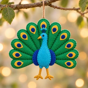 May include: A felt peacock ornament featuring a bright blue body, yellow legs, and a large, fanned tail made of green felt segments. Each tail segment is decorated with a yellow and blue eye-spot pattern. The ornament hangs from a thin brown twine.