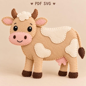May include: A felt cow craft pattern featuring the text PDF SVG. The cow is light tan with cream-coloured patches, dark brown horns and hooves, and a pink snout and inner ears. It has black eyes and a stitched mouth, with visible blanket stitching.