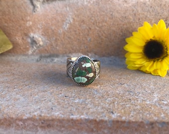 Multi colored green brown webbed turquoise freeform ring on roller printed southwestern pattern recycled silver band