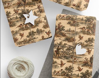 May include: Rectangular packages wrapped in beige paper featuring a repeating hunting scene print with figures, dogs, and birds in brown and green tones. Each package is tied with brown twine and includes a plain white star or heart-shaped tag.