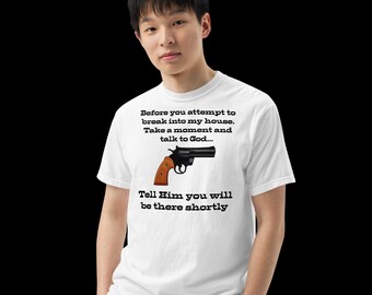 Puede incluir: Camiseta blanca con una imagen de un revólver negro con empuñadura marrón. La camiseta tiene el texto: "Antes de intentar entrar en mi casa. Tómate un momento y habla con Dios... Dile que estarás allí pronto."