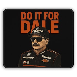 May include: Black mousepad featuring a portrait of a man wearing sunglasses and a black cap with the words "DO IT FOR DALE" in orange. The man is wearing a black jacket with sponsor logos.