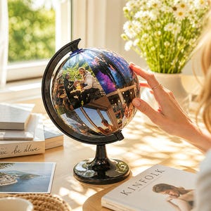 May include: A custom globe featuring a collage of personal photographs printed directly onto the surface. The globe is mounted on a black plastic stand with a circular base and a curved arm, allowing the sphere to rotate within the frame.