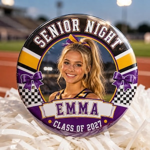 May include: A circular button featuring a photograph of a smiling person with blonde hair in a ponytail. The border includes the text SENIOR NIGHT, EMMA, and CLASS OF 2027, decorated with purple bows, yellow stripes, and a black and white checkered pattern.