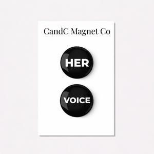 May include: Two black round magnets with white text. The top magnet reads "HER", and the bottom magnet reads "VOICE". The magnets are on a white background with the text "CandC Magnet Co" at the top.