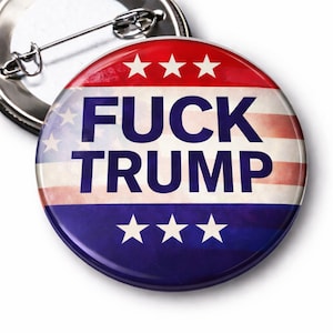 May include: A round button pin with a red, white, and blue design, featuring the text "FUCK TRUMP" in bold, capital letters. The pin has a metal clasp on the back.