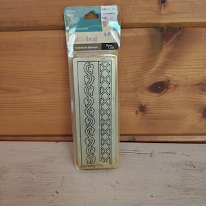May include: A rectangular metal cutting die for crafting, encased in clear plastic packaging. The die features two distinct vertical patterns: a repeating leaf vine design on the left and a geometric diamond grid on the right. Text includes Cuttlebug.