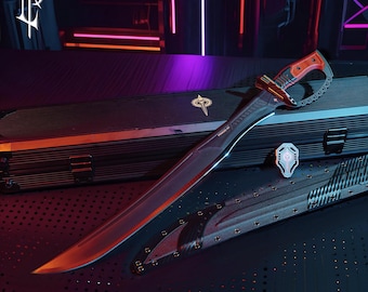 May include: A long, curved sword with a red and brown handle and a black blade. The sword rests on a black case with a matching sheath. A silver emblem and a small shield-shaped pin are also present.