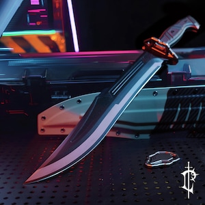 May include: A large, black and silver blade with a curved handle and a decorative guard. The blade has a sharp point and a reflective surface. The handle is textured and appears to be made of a composite material. A small, silver emblem is visible.