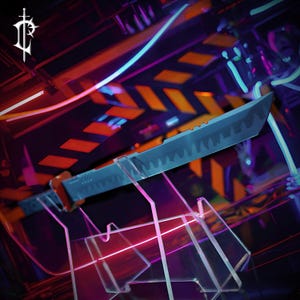 May include: A futuristic-style sword with a blue blade and orange handle is displayed on a clear acrylic stand. The background features neon lights in pink, orange, and blue, creating a vibrant, high-tech aesthetic. The sword's design suggests a focus on fantasy or gaming.